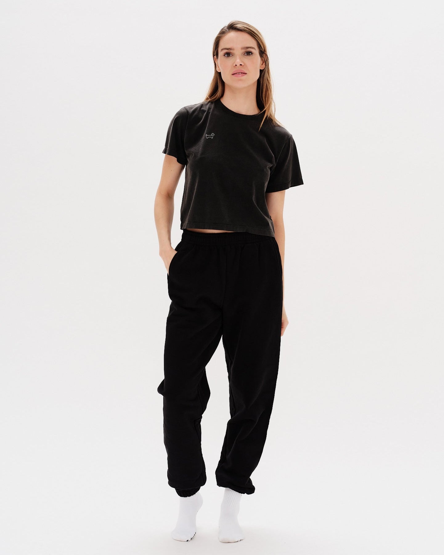 Woman wearing a black t-shirt with a wiener dog embroidery