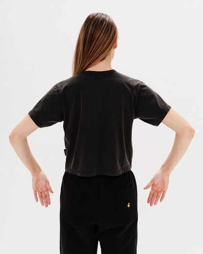 Woman wearing a black t-shirt with an I don't want to work embroidery
