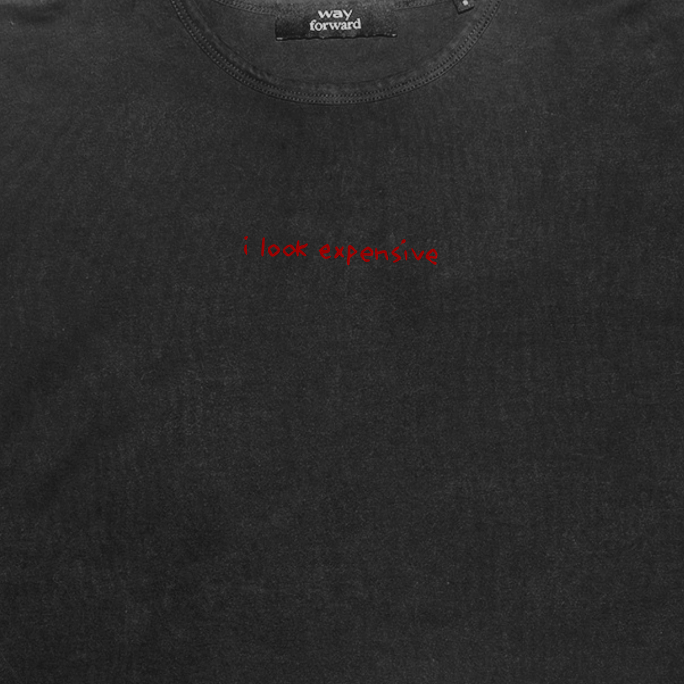 Black t-shirt with red text 'i look expensive' on a plain background