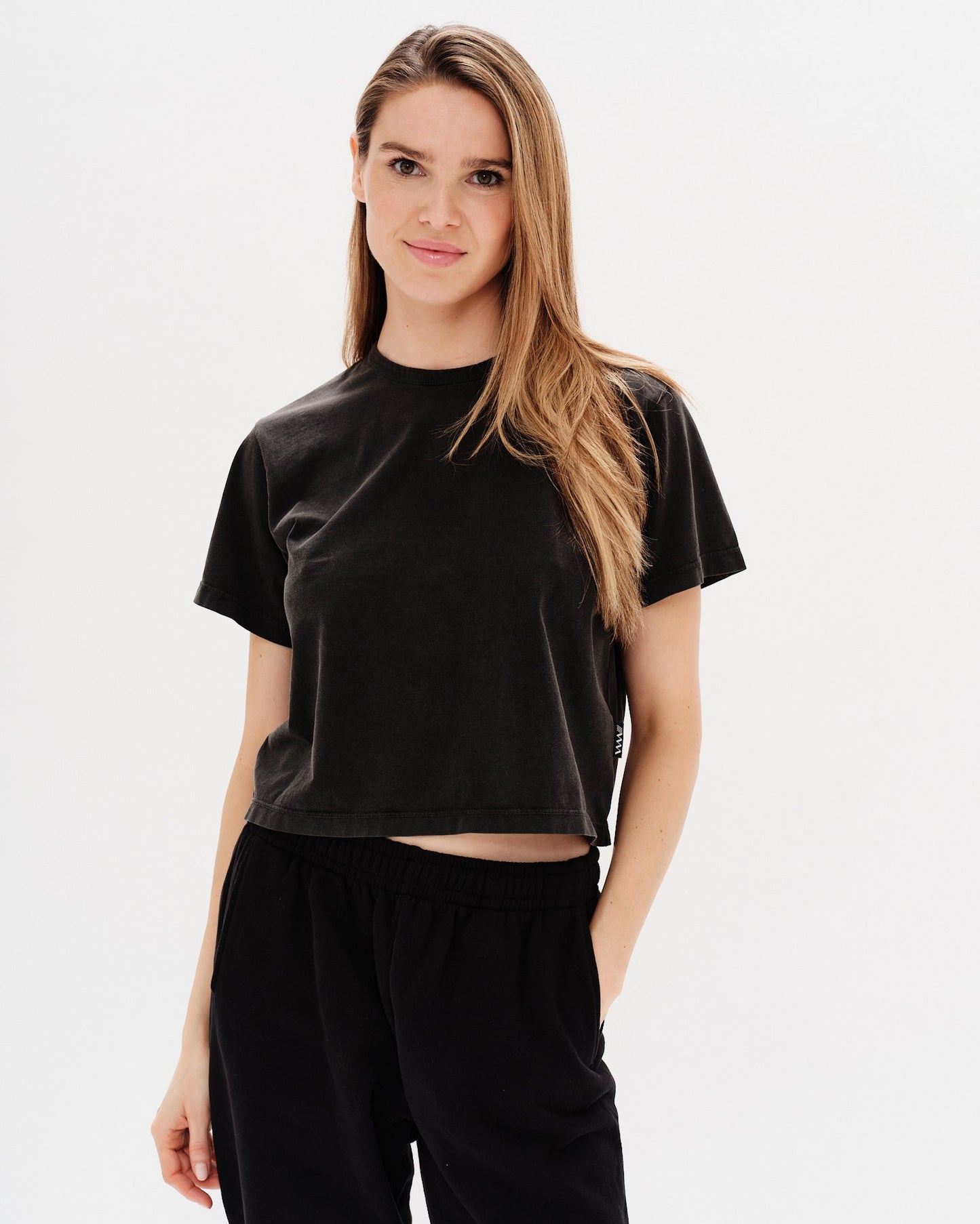 Woman wearing a black t-shirt and black pants