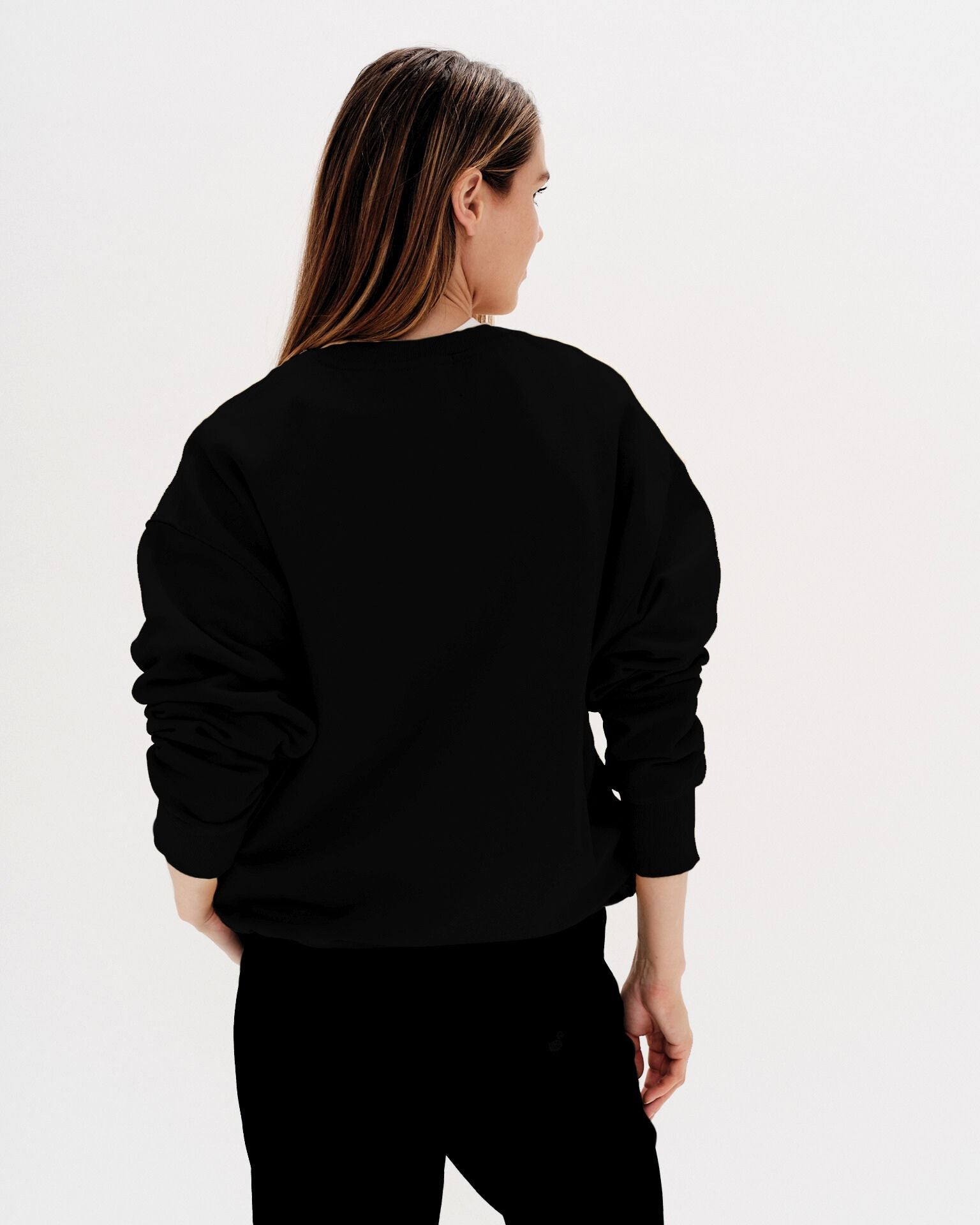 Woman wearing a black sweatshirt with a diet coke embroidery