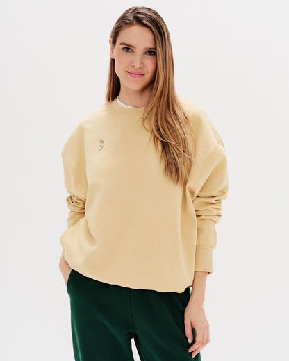 Woman wearing a yellow sweatshirt with a long hair wiener dog embroidery