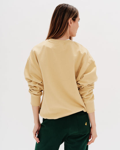 Woman wearing a yellow sweatshirt with a long hair wiener dog embroidery