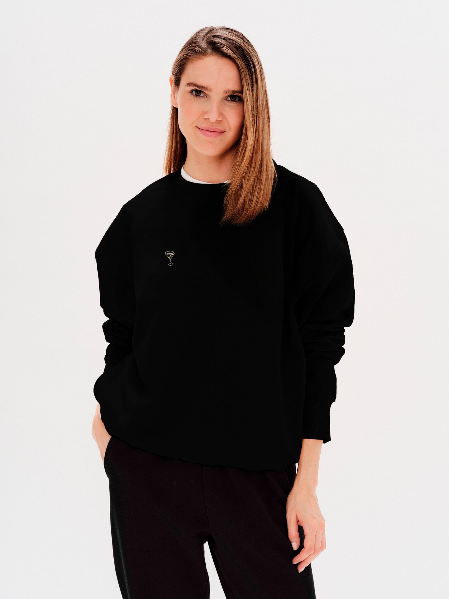 Woman wearing a black sweatshirt with a martini embroidery