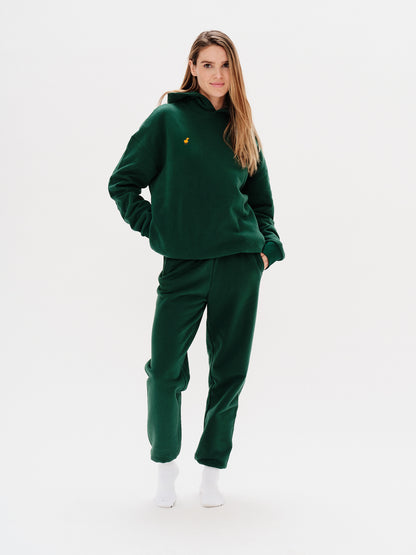 Woman wearing a premium green hoodie with a duck embroidery