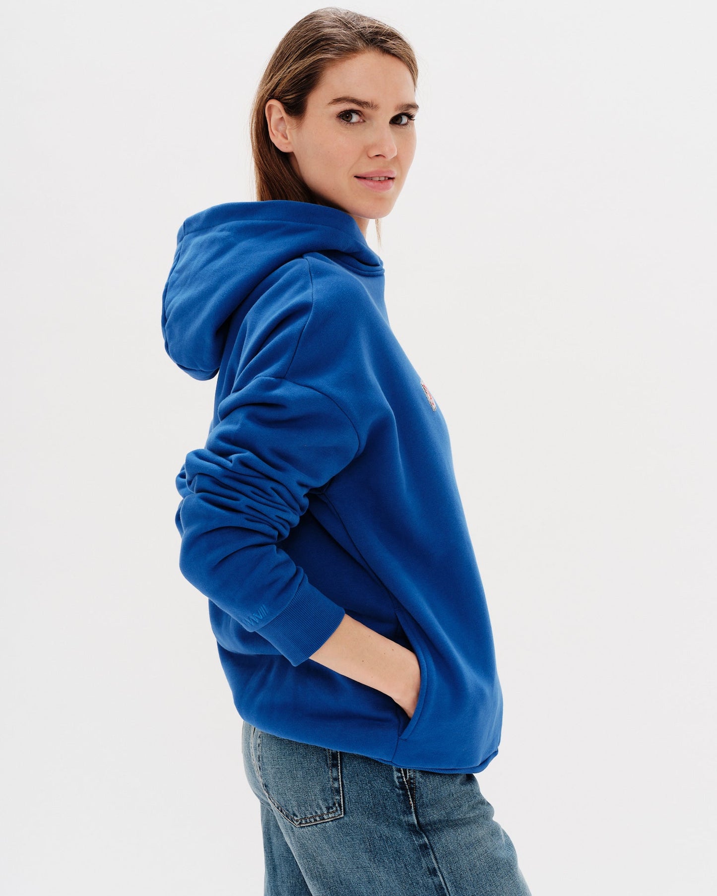 Woman wearing a blue hoodie with an I don't know what I want embroidery text