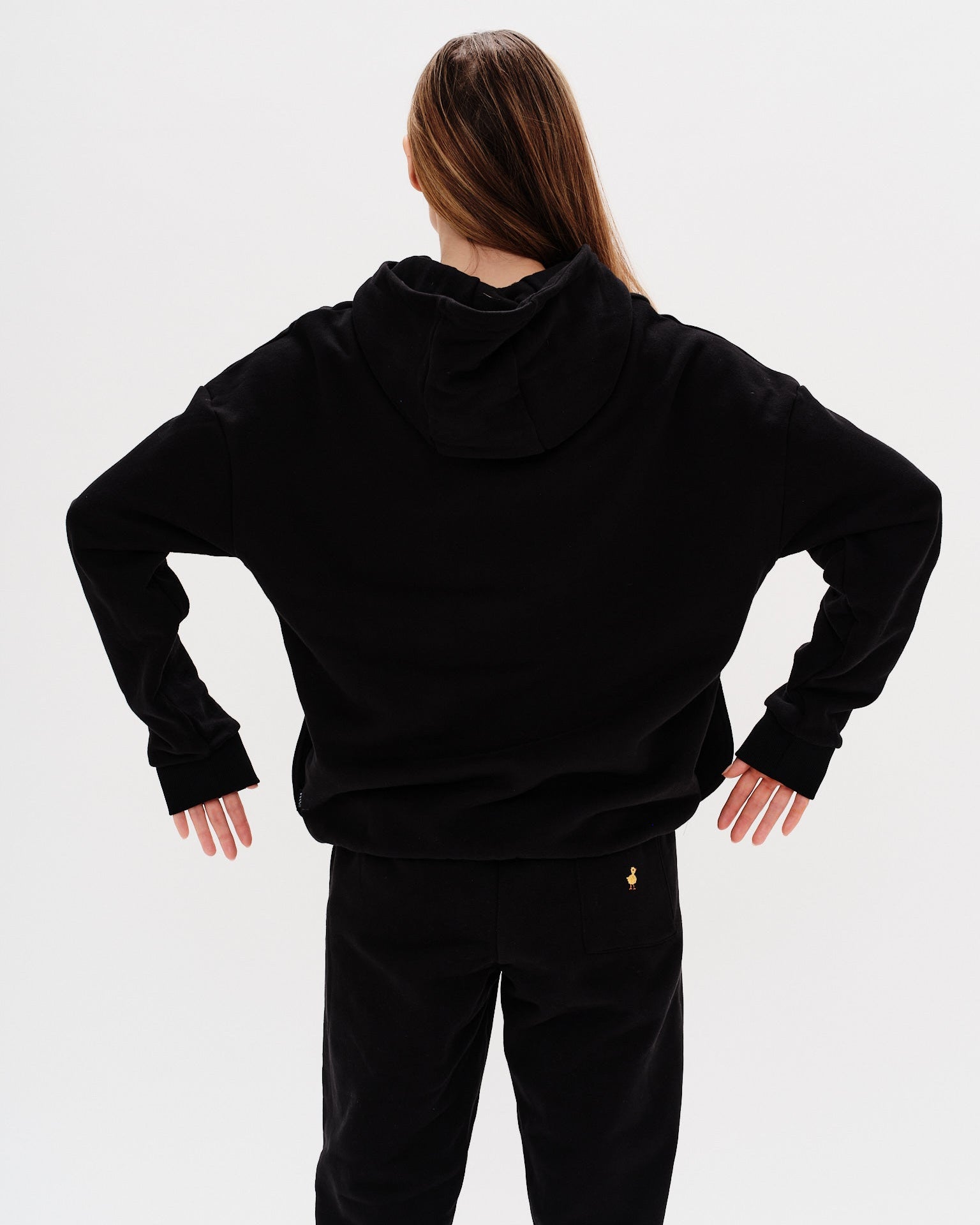 Woman wearing a premium black hoodie and pants