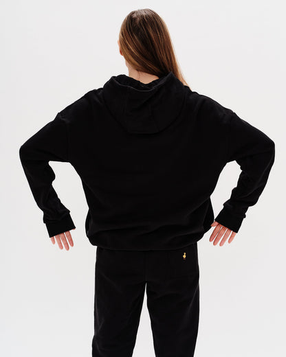 Woman wearing a premium black hoodie and pants