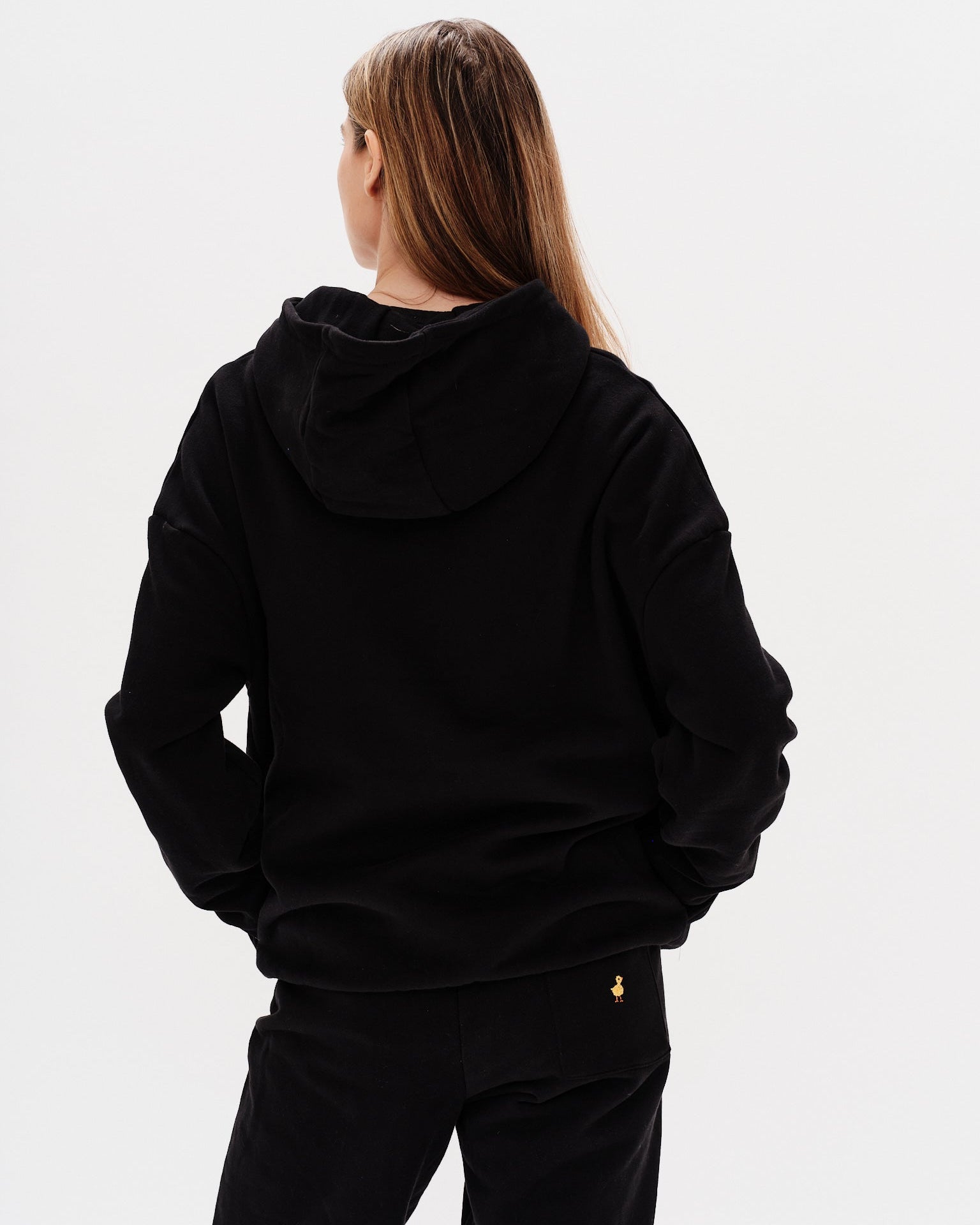 Woman wearing a premium black hoodie and pants