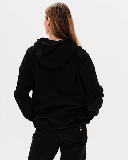 Woman wearing a premium black hoodie and pants