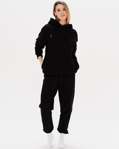 Woman wearing a premium black hoodie and pants