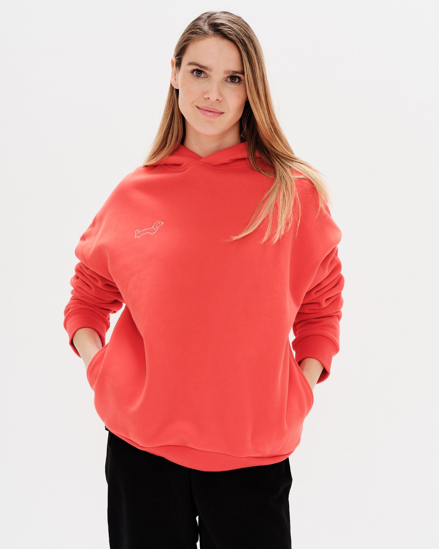 Woman wearing a red hoodie with a wiener dog embroidery