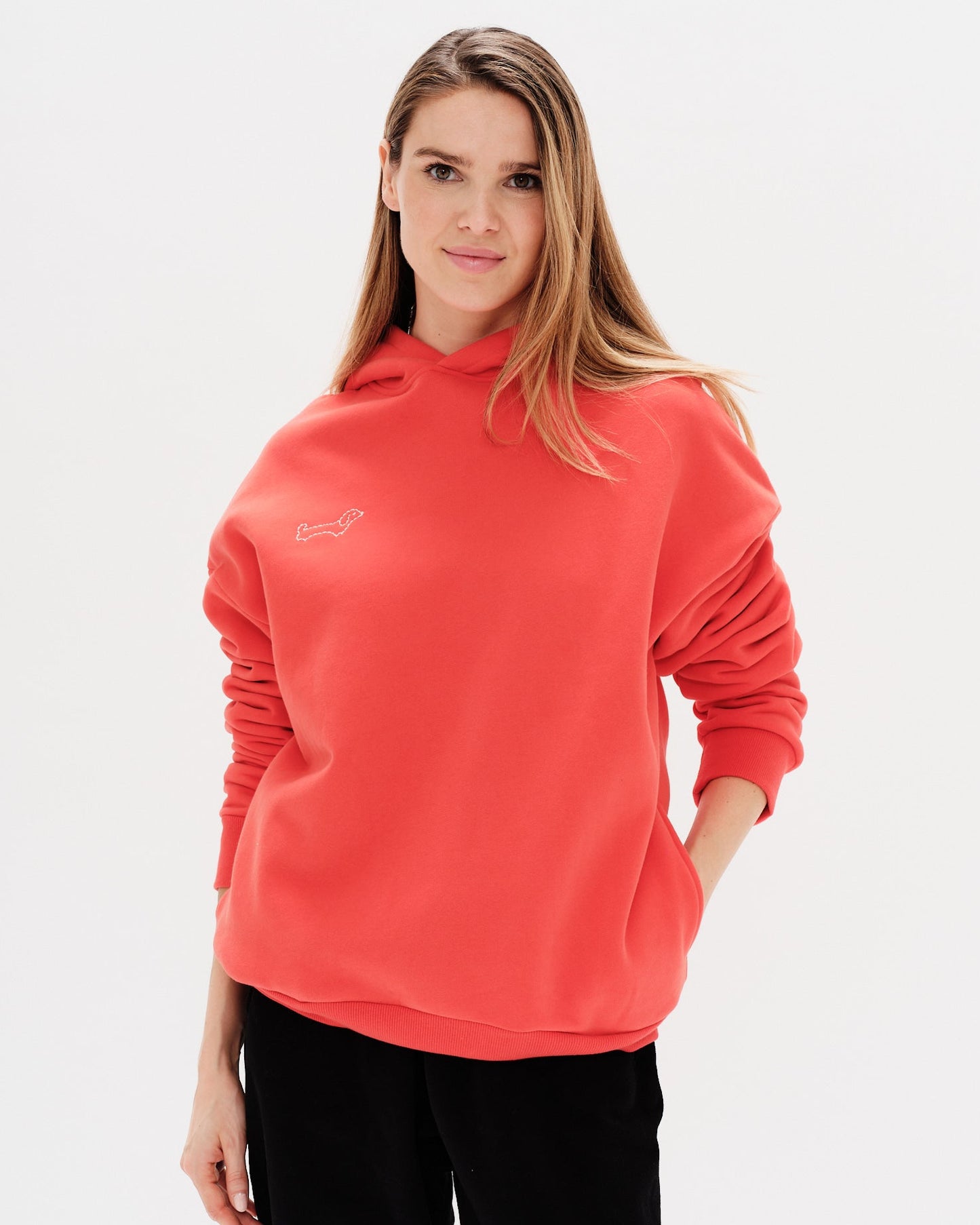 Woman wearing a red hoodie with a wiener dog embroidery