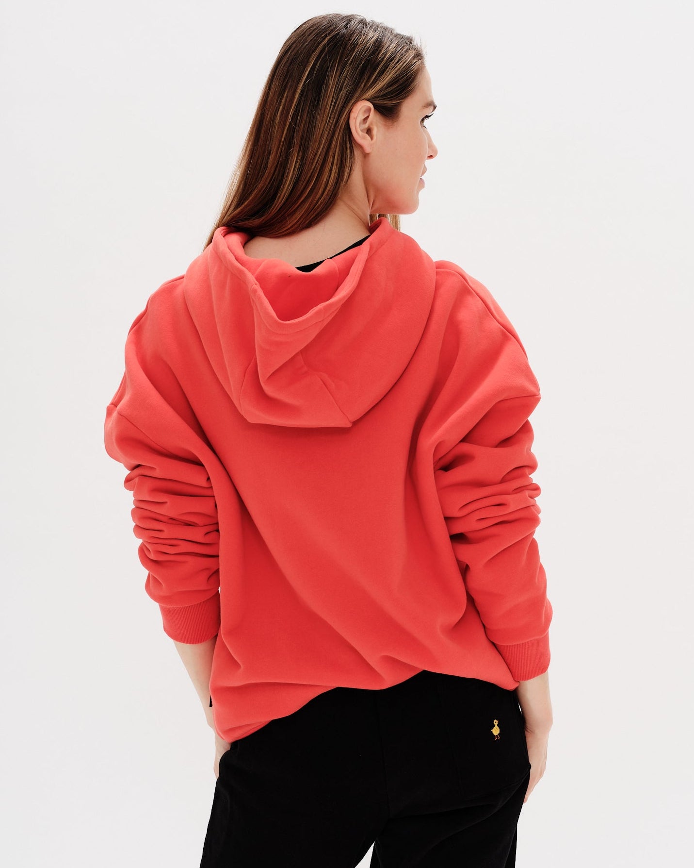 Woman wearing a red hoodie with a wiener dog embroidery