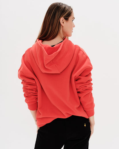 Woman wearing a red hoodie with a wiener dog embroidery