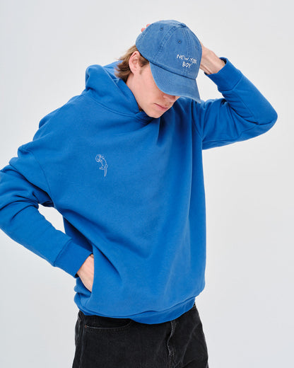 Man wearing a blue hoodie and cap