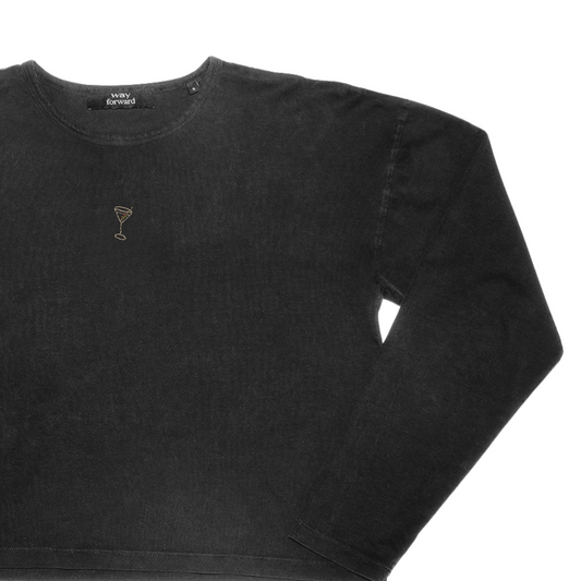 A black long sleeve crop top with a small embroidered martini glass design on the chest.