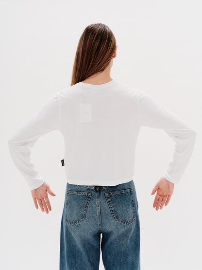 Woman wearing a white long-sleeve t-shirt with a New York Lover embroidery