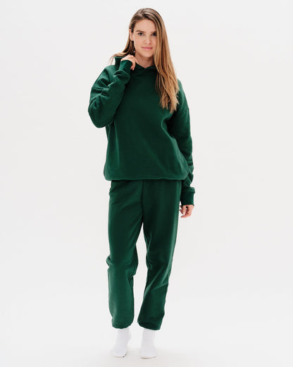 Woman wearing green pants with a Diet Coke embroidery