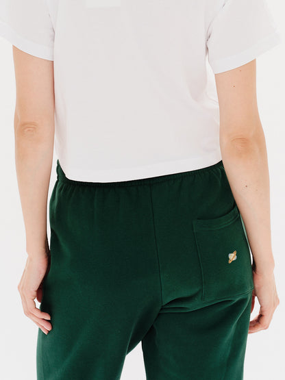 Woman wearing green pants with a planet embroidery