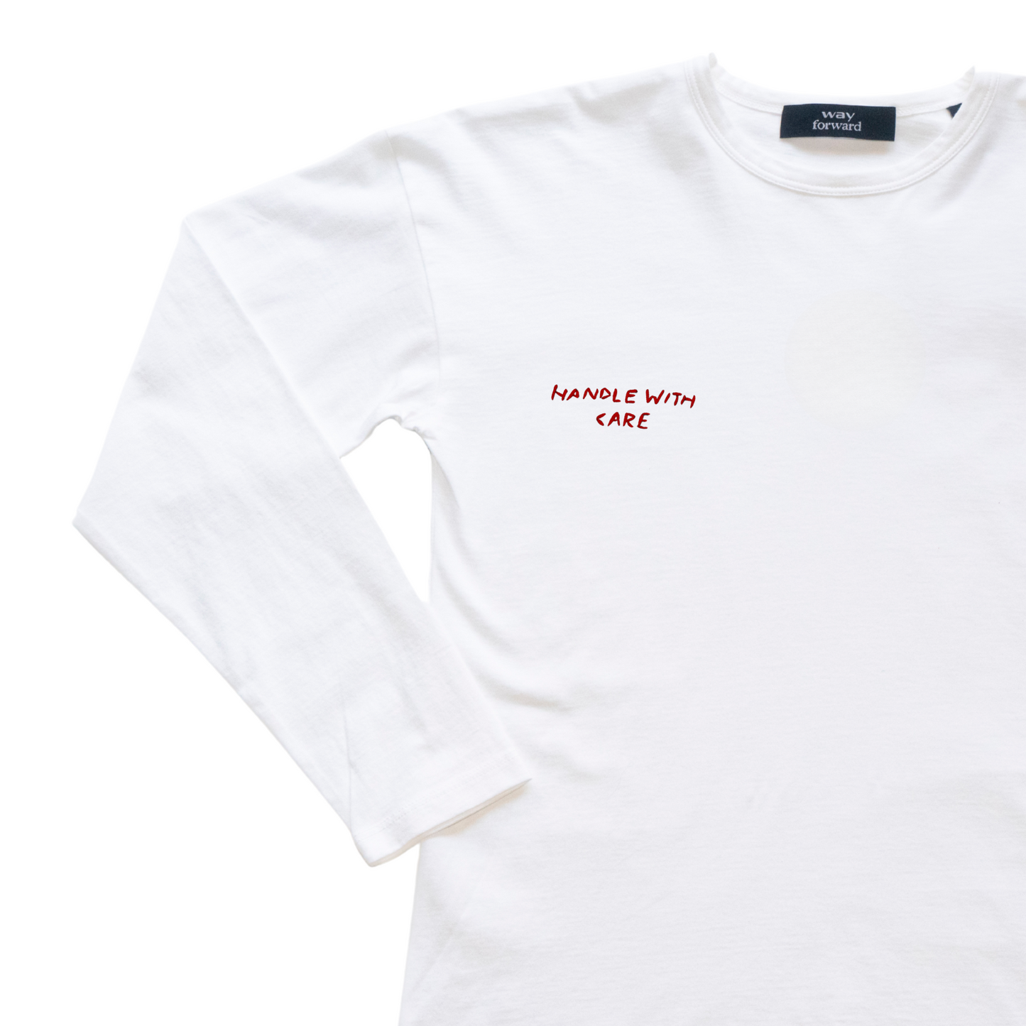 White t-shirt with 'Handle with Care' text on a white background