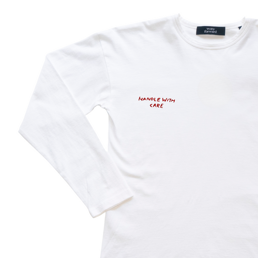 White t-shirt with 'Handle with Care' text on a white background