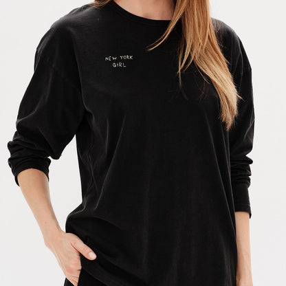 Woman wearing a black long-sleeve t-shirt with a New York Gril embroidery