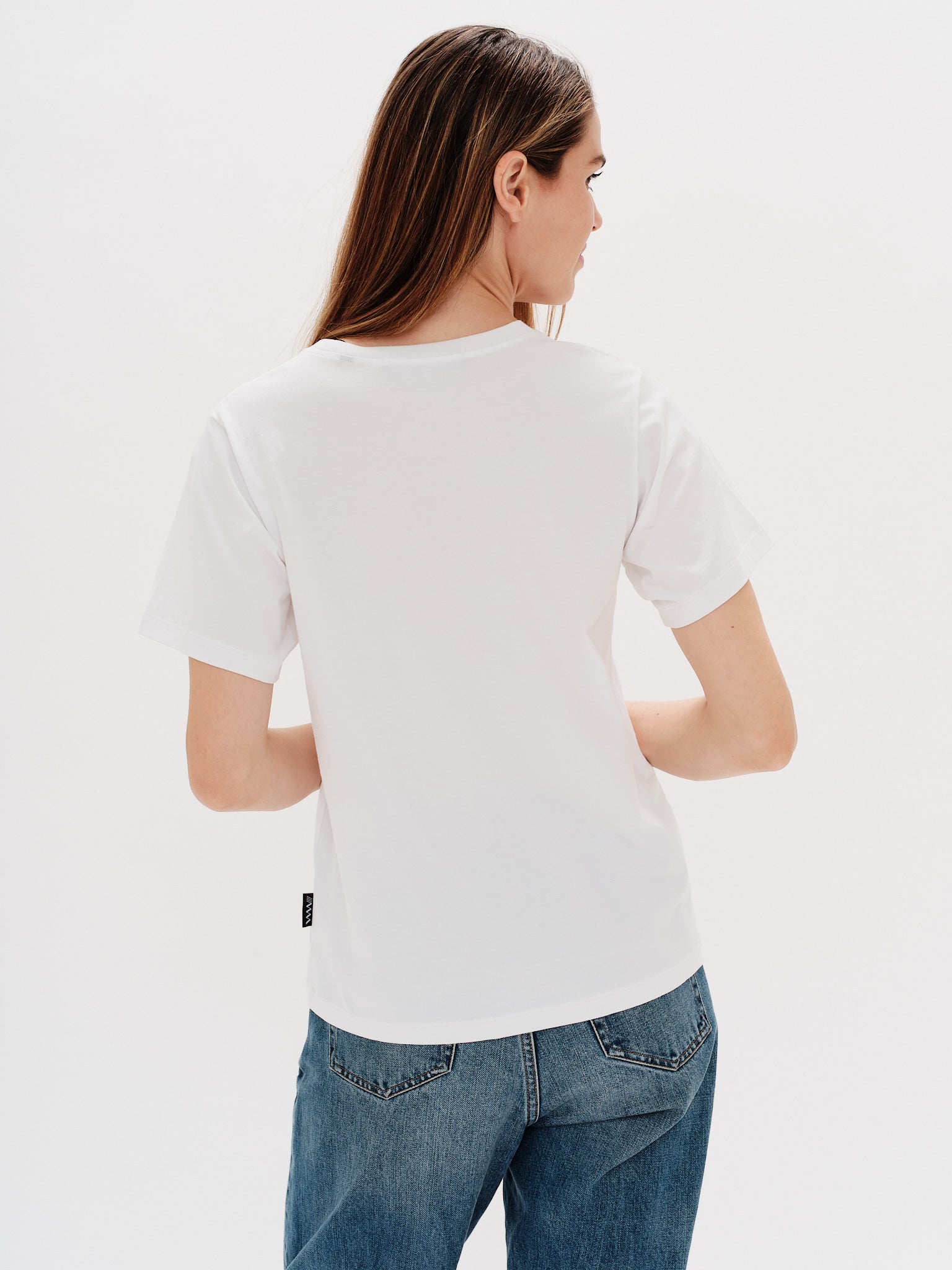 Woman wearing a white t-shirt with a i don't know what i want embroidery
