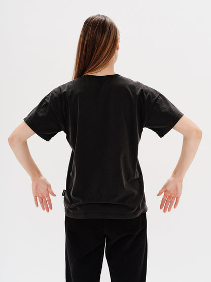 Woman wearing a black t-shirt with a Long Hair Wiener Dog embroidery