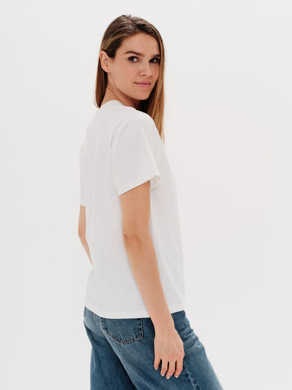 Woman wearing a white t-shirt with martini embroidery