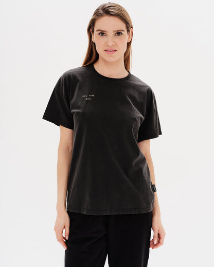 Woman wearing a black t-shirt with a i New York Girl embroidery