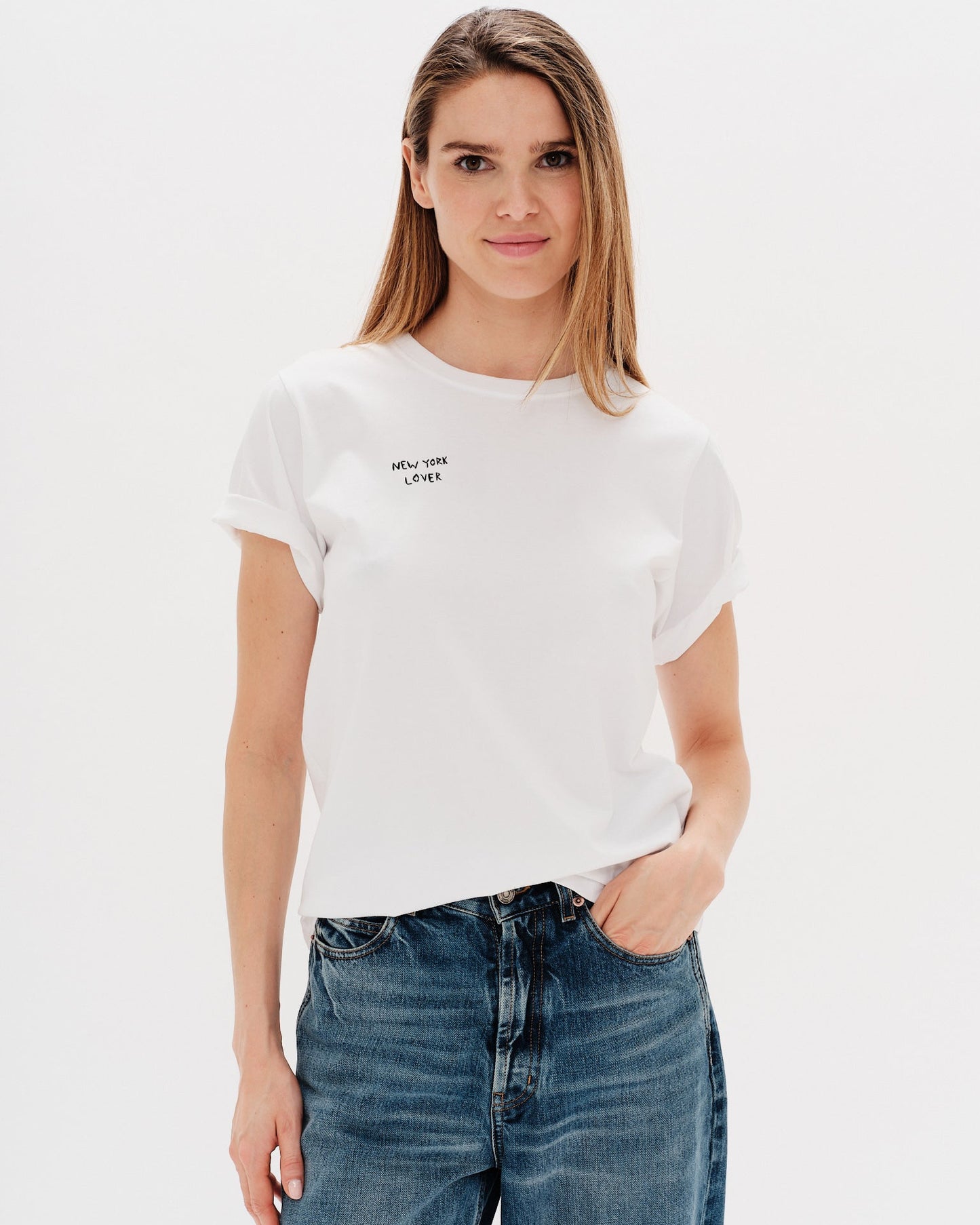 Woman wearing a white t-shirt withNew York Lover embroidery