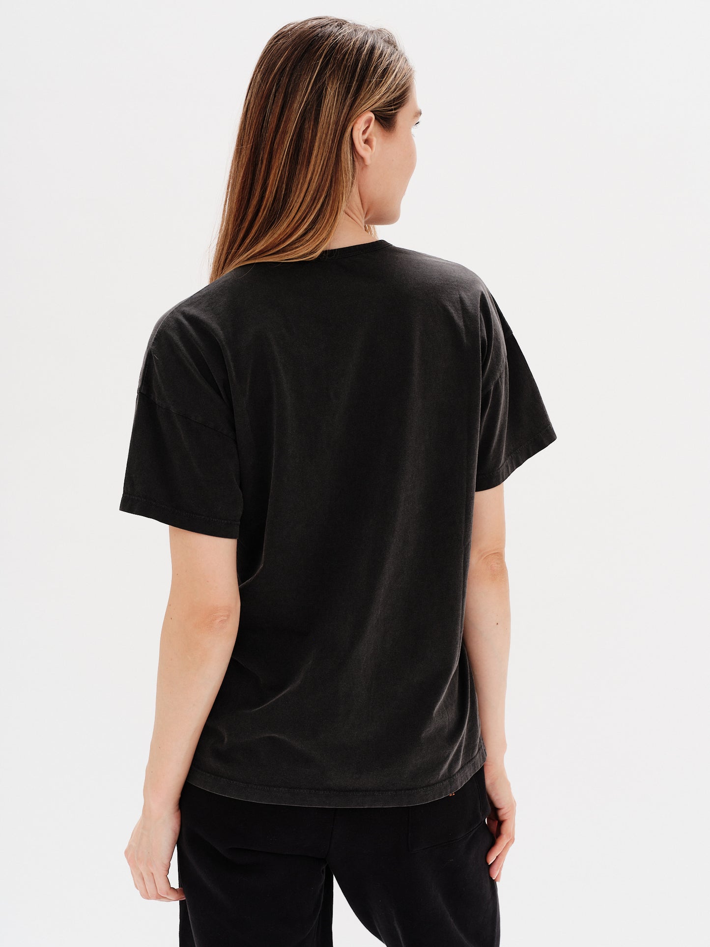 Woman wearing a white t-shirt with planet embroidery