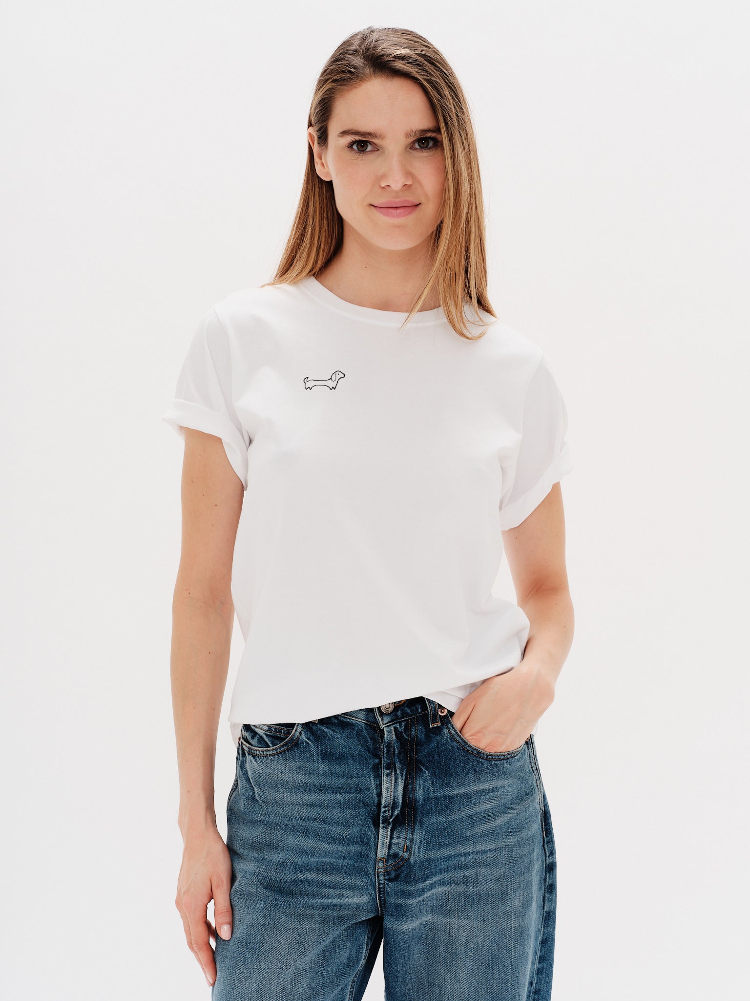 Woman wearing a white t-shirt with Wiener Dog embroidery