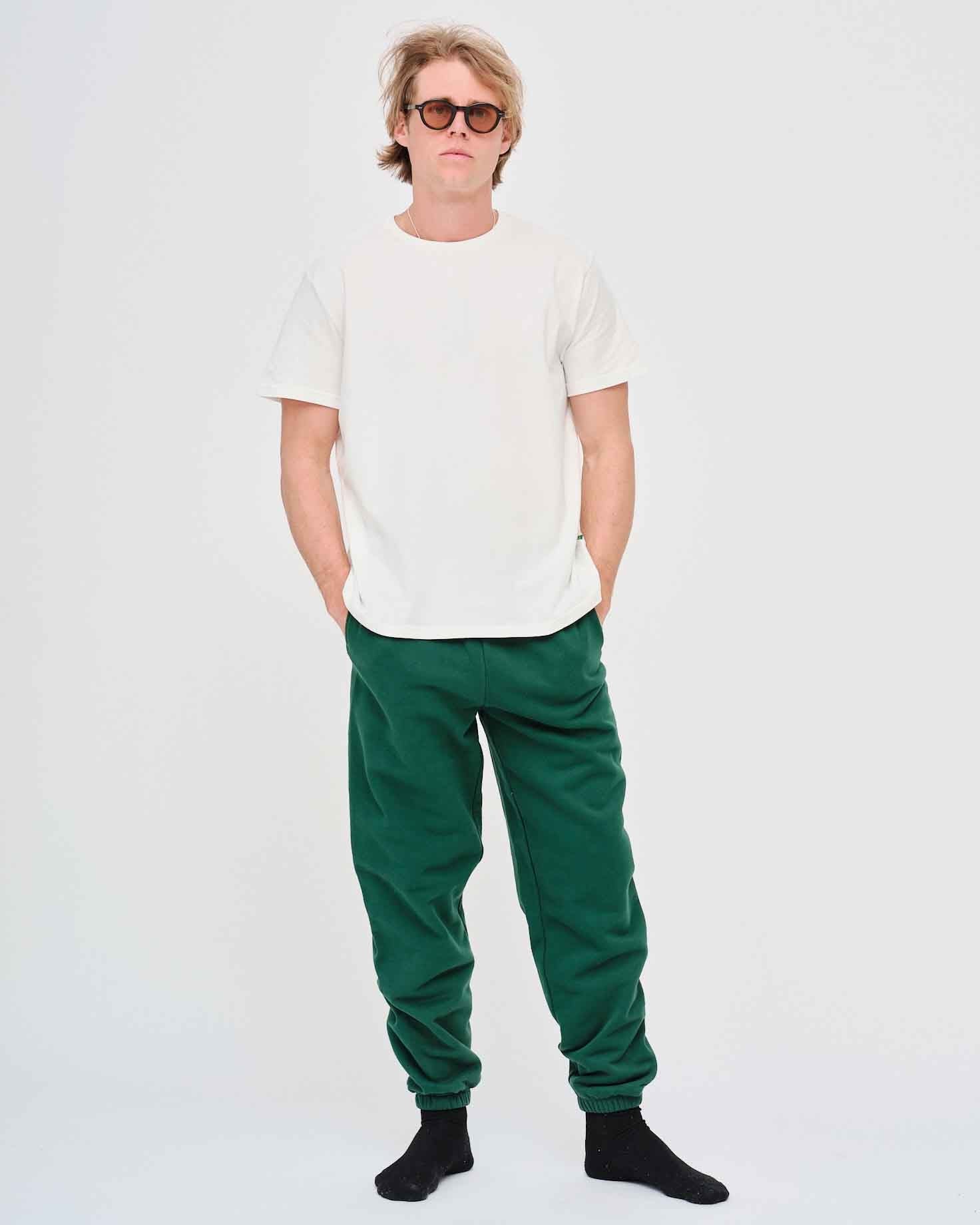 Man wearing a white t-shirt and green pants