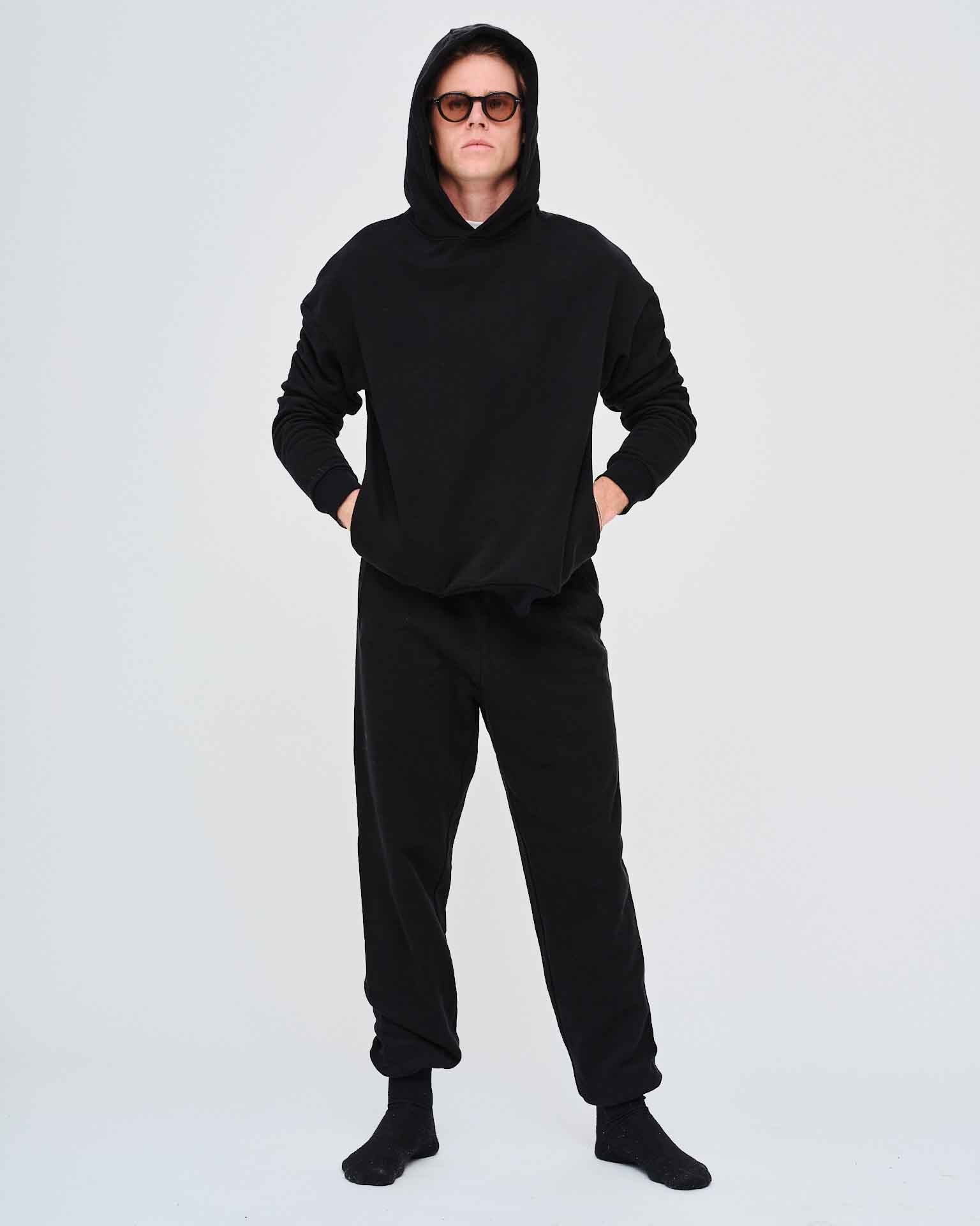 Man wearing a black hoodie and pants