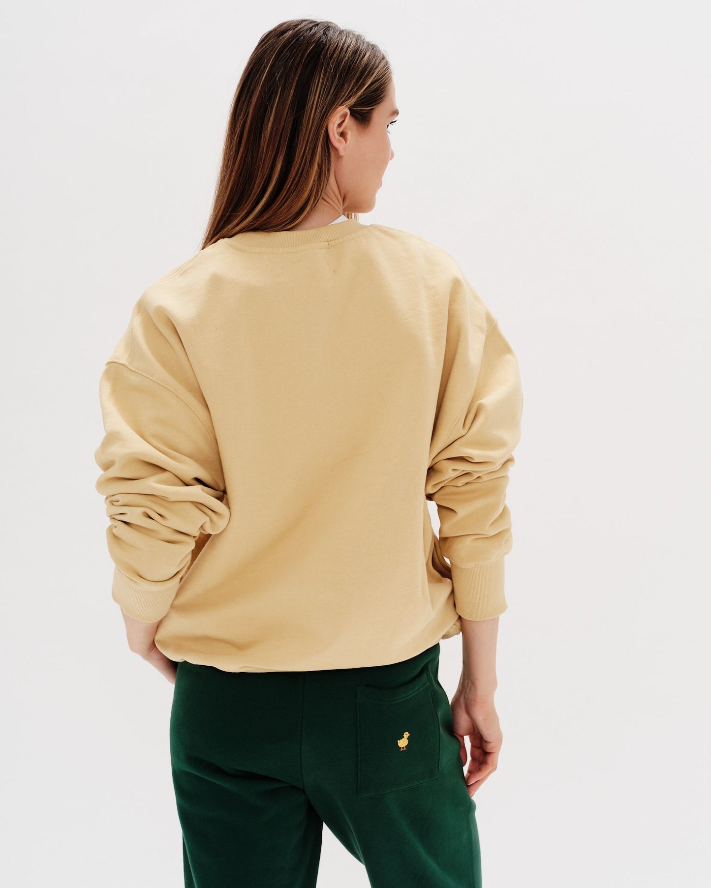 Yellow sweatshirt with text 'i don't know what i want' worn by a woman